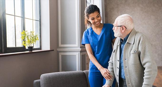 Professional caregiver providing personalised home care in Seaford while assisting an elderly person in their own home.